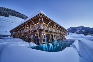 a wooden building in the snow with snow covered at HUBERTUS Mountain Refugio Allgäu in Balderschwang