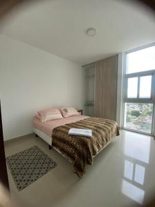 a bedroom with a bed and a large window at Exclusive, Elegant Atlantis Comfortable in Santa Cruz de la Sierra