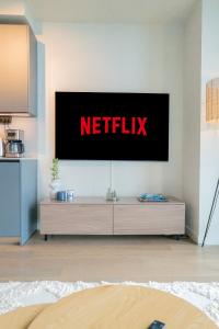 a television on a wall with the netflix sign on it at Karlatornet Sky Level in Gothenburg