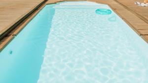 a swimming pool with a frisbee in the water at 13 Olives, Entire Grape & Olive Estate, Somerset West by Euphoric Leisure in Sir Lowryʼs Pass