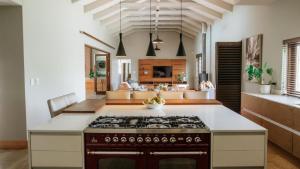 a kitchen with a stove top oven in a room at 13 Olives, Entire Grape & Olive Estate, Somerset West by Euphoric Leisure in Sir Lowryʼs Pass