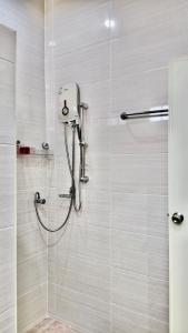 a bathroom with a shower with a glass door at Phra Singh 64 Old City Center Stay in Chiang Mai +78 photos