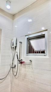 a shower in a bathroom with a window at Phra Singh 64 Old City Center Stay in Chiang Mai