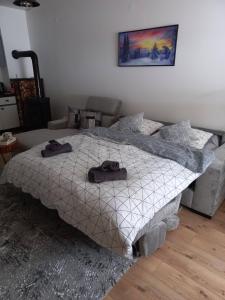 a bedroom with a bed with two hats on it at Apartman Afano in Jahorina
