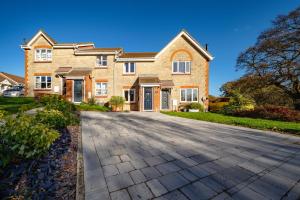 a large brick house with a driveway at Two Bed Home in Portishead in Portishead