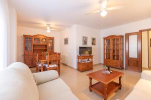 a living room with a couch and a table at Apartamentos Miguel Angel in Estepona