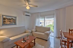 a living room with a couch and a table at Apartamentos Miguel Angel in Estepona