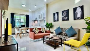 a living room with a couch and chairs and a table at Phra Singh 64 Old City Center Stay in Chiang Mai