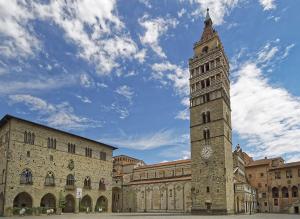 a tall clock tower in front of a building at Il Leoncino Loft con vista sulla Piazza in Pistoia