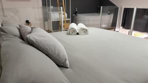 a white bed with two slippers on top of it at Figli Di Agata in Catania