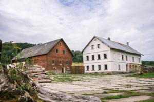 two buildings next to each other on a field at Statek 85 in Mařenice
