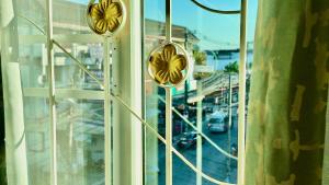 a window with a view of a city street at Phra Singh 64 Old City Center Stay in Chiang Mai