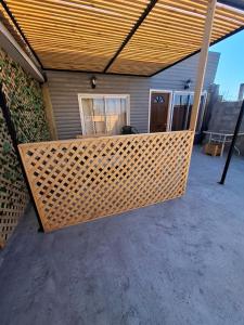a large wicker patio with awning on a house at Cabaña caldera centro in Caldera