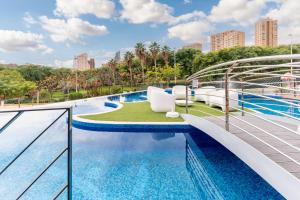 a view of a swimming pool at a resort at Amazing Apartment in Benidorm - Sunset in Benidorm