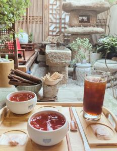 a tray with two bowls of soup and a drink at Dazzlday in Seoul