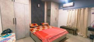 a bedroom with a bed in a room with a closet at GK appartments in Bengaluru