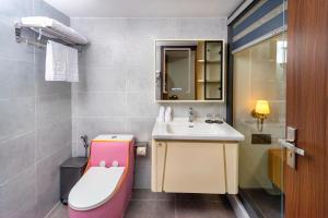 a bathroom with a sink and a toilet at Palado Hotel Mui Ne in Ấp Thiện Phước +34 photos