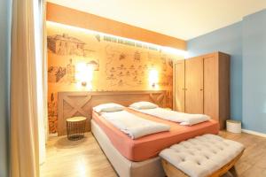 a bedroom with a bed and a mural on the wall at 1 BR Wine Journey in Sofia