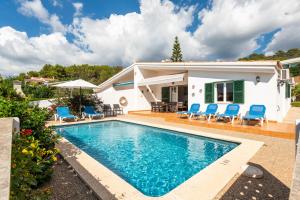 a villa with a swimming pool in front of a house at Villa Noelia by Escape Home in Santo Tomás