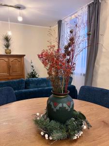 a vase sitting on top of a table with flowers at Reval Residences Old Town in Tallinn