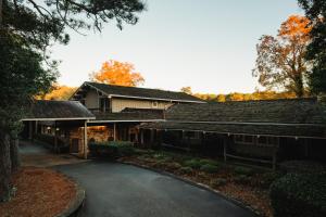 a house with a driveway in front of it at Pine Needles Lodge in Southern Pines