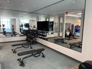 a gym with a large mirror and rows of exercise equipment at Hyatt Place Toronto Airport in Toronto