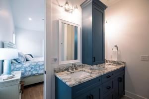a bathroom with a blue sink and a mirror at Glory Be in Edisto Island +50 photos