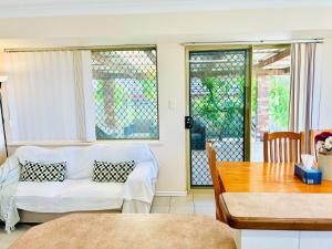 a living room with a white couch and a table at Pet friendly home near Adventure World Fiona Murdoch in Perth