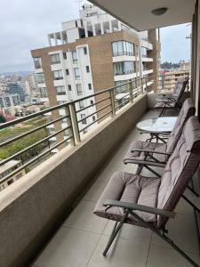 a balcony with chairs and tables on a building at Viña del Mar Department in Viña del Mar