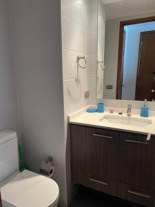 a bathroom with a sink and a toilet and a mirror at Viña del Mar Department in Viña del Mar