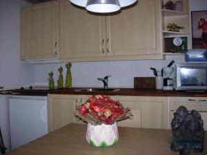 a kitchen with a vase of fruit on a table at Travel back in time in Nyord