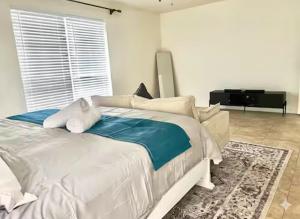 a white bed with a stuffed animal laying on it at Cozy Private Room in Milton near Beaches in Milton