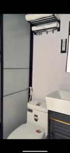 a small bathroom with a toilet and a sink at The mirage dome in Badīyah +18 photos