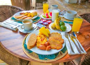 a table with plates of breakfast food on it at Hotel Isla Palma Reserva Natural in Isla Palma