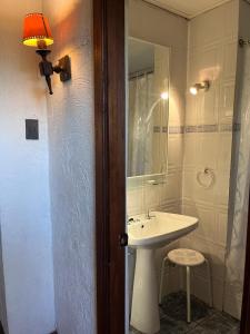 a bathroom with a sink and a mirror at Lodge Boutique Casa Cardonal in Paine +28 photos