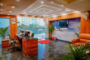 an office with a desk with a computer and an airplane on the wall at Keerthis Grand Hotel near Kempegowda International Airport in Bangalore