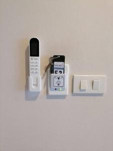 two cell phones in a holder on a wall at AtWhitePatong in Patong Beach +19 photos