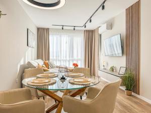 a dining room and living room with a table and chairs at Skyline Serenity Modern Apartment with Terrace by Flat Manаger in Plovdiv
