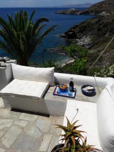 eine weiße Couch auf einer Terrasse mit Meerblick in der Unterkunft Exclusive Beach House in Gavrio
