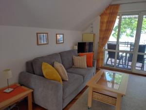 a living room with a couch and a table at Ferienwohnung Seeblick 222 in Koserow