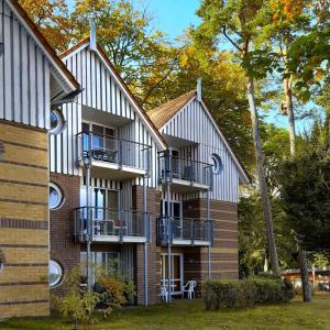 a building with balconies on the side of it at Ferienwohnung Seeblick 222 in Koserow