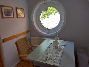 a table with a bottle on it with a window at Ferienwohnung Seeblick 222 in Koserow +13 photos