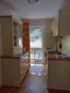 a kitchen with a large window and a counter top at Ferienwohnung Seeblick 222 in Koserow