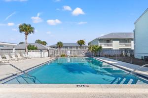 a swimming pool in front of a house at Southwind by Panhandle Getaways in Panama City Beach