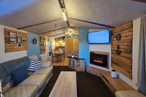 a living room with a couch and a tv at Riverscape Northumberland in Ashington