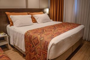 Ένα ή περισσότερα κρεβάτια σε δωμάτιο στο Hotel Plaza Camboriú