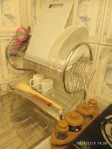 a kitchen counter with a strainer and utensils at Polycap Cottage Home in Murangʼa