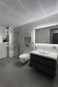 a bathroom with a sink and a toilet and a shower at Elegant Ephesus Suites - Hadrian in Selçuk +77 photos