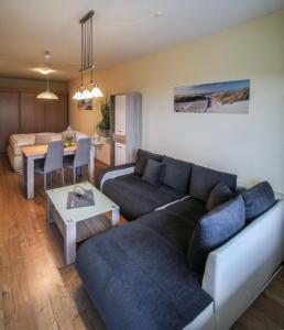 a living room with a couch and a table at Vier Jahreszeiten 2-52 in Großenbrode