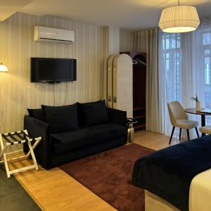 a living room with a couch and a bed at Be Oporto Apartments Clérigos in Porto